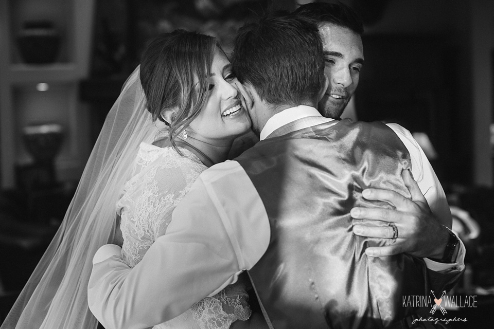 bride and groom hug family