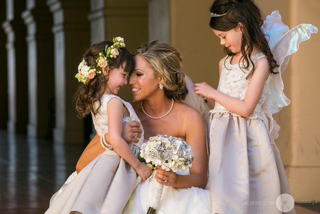 The bride share a hug and a kiss with the flower girls just before the Brophey Chapel ceremony