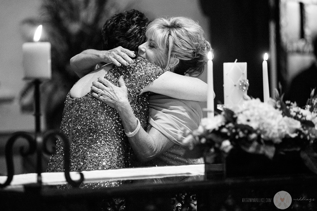 The mothers of the bride and the groom have a hug as they participate in the Brophey Chapel ceremony