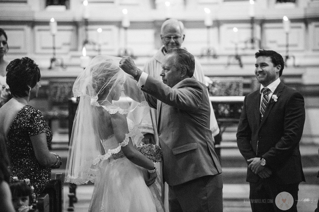 The father unveils the bride during the start of the Brophey Chapel ceremony