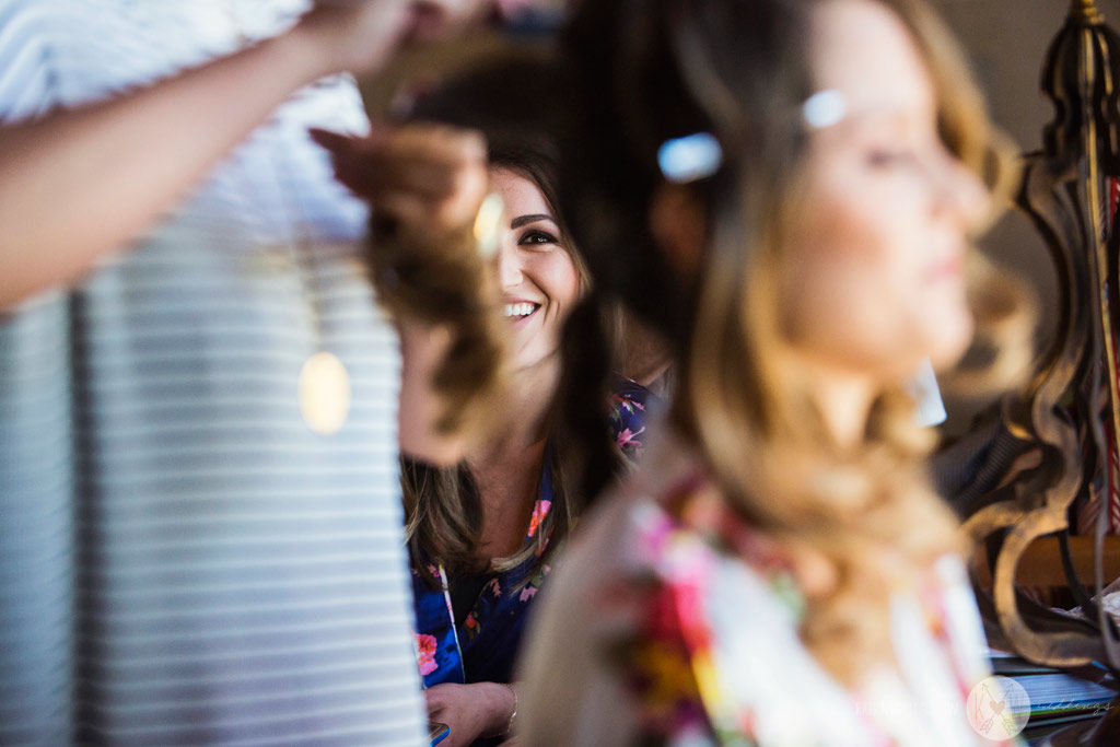 The bride and her bridemaid have hair and makeup done before the wedding ceremony at the Four Seasons Scottsdale