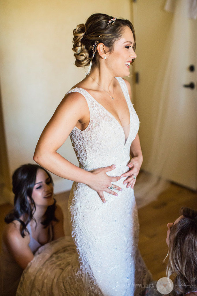 After getting into her gown, the beautiful bride blushes with excitement as the ceremony draws nearer at the Four Seasons Scottsdale