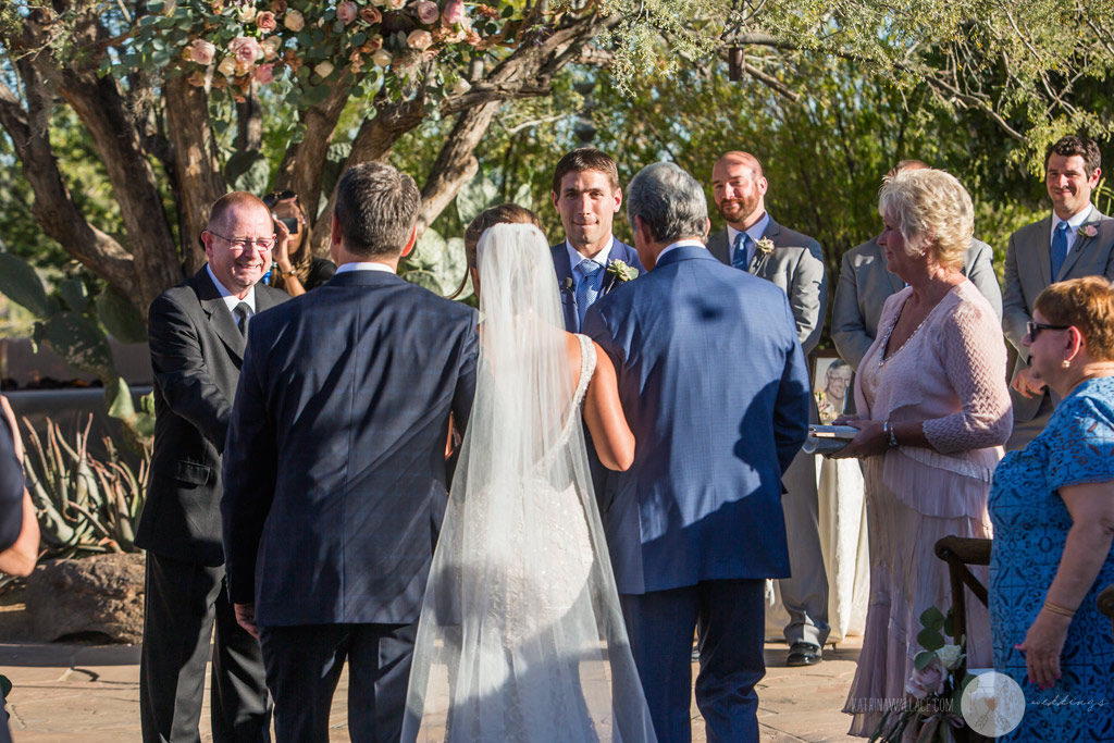 The Father of the bride hands off his daughter to the groom as they start their new family together.