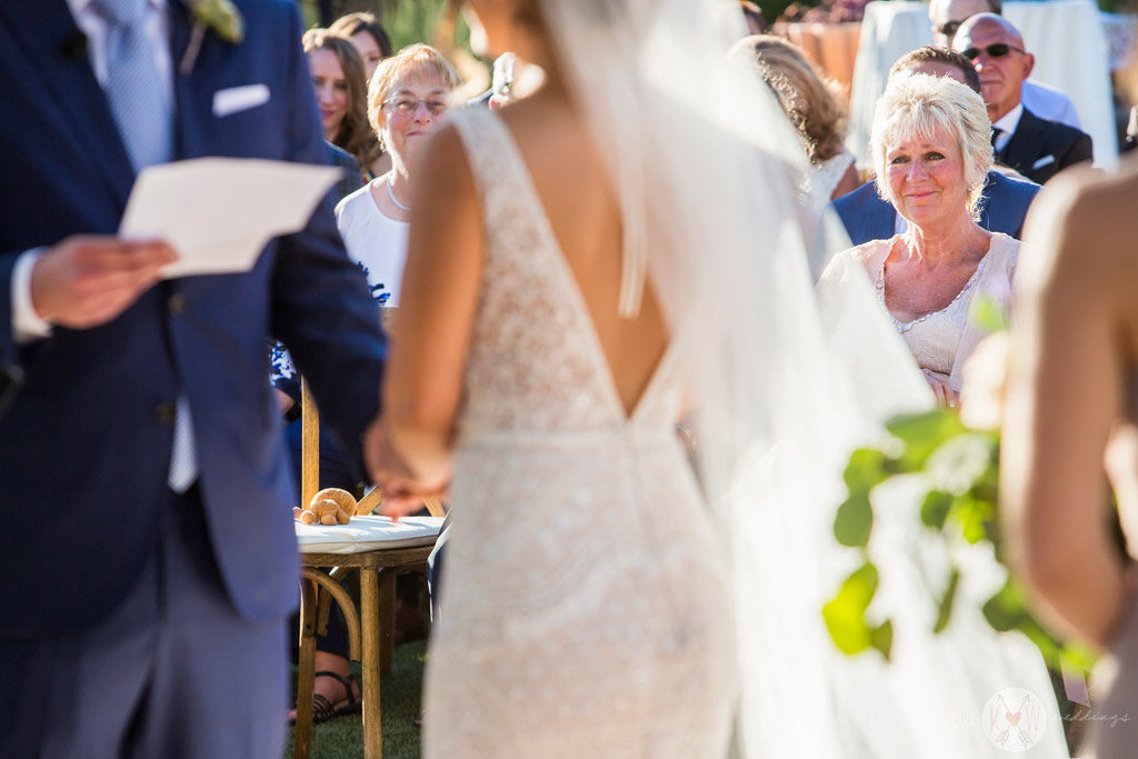 The Mother of the groom watches on with pride as her son reads his vows to his bride.