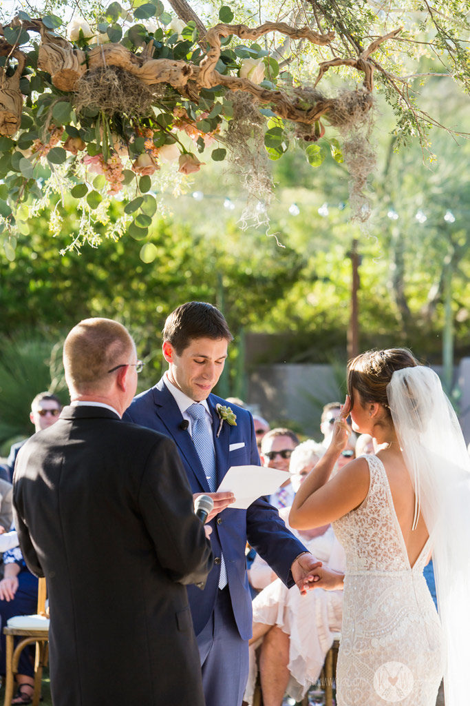 The groom reads his vows to the bride.