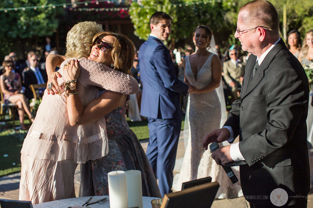 A view of the wedding ceremony from behind the bridesmaids at the Four Seasons Scottsdale