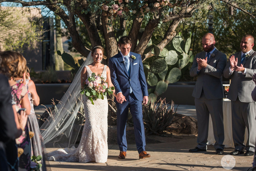 The kiss! The bride and groom are officially married at the Four Seasons Scottsdale wedding ceremony.