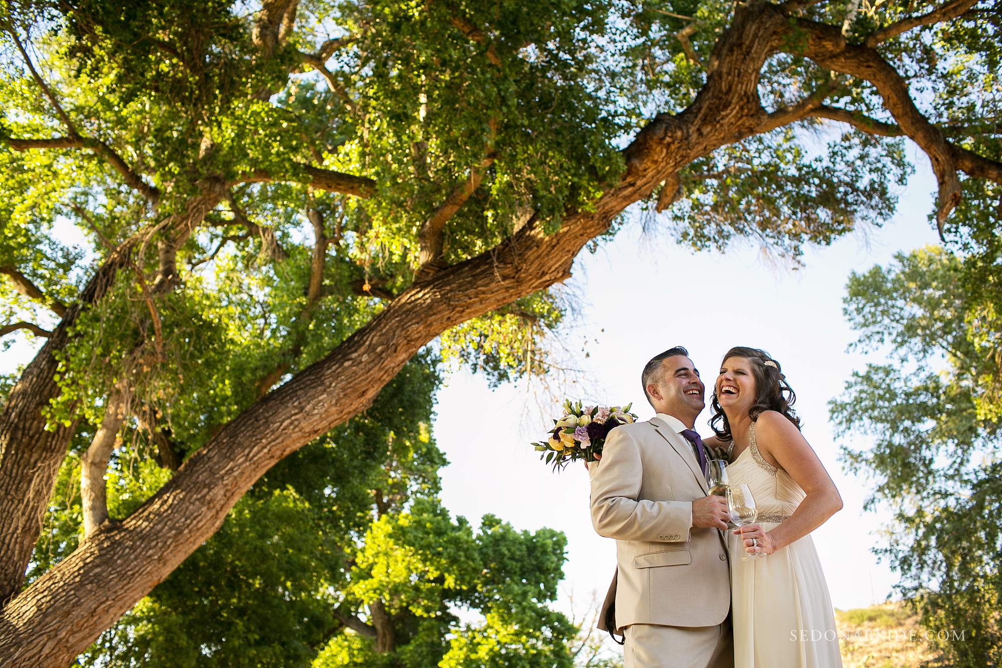 Dancing Apache Lodge wedding photos under tall green trees
