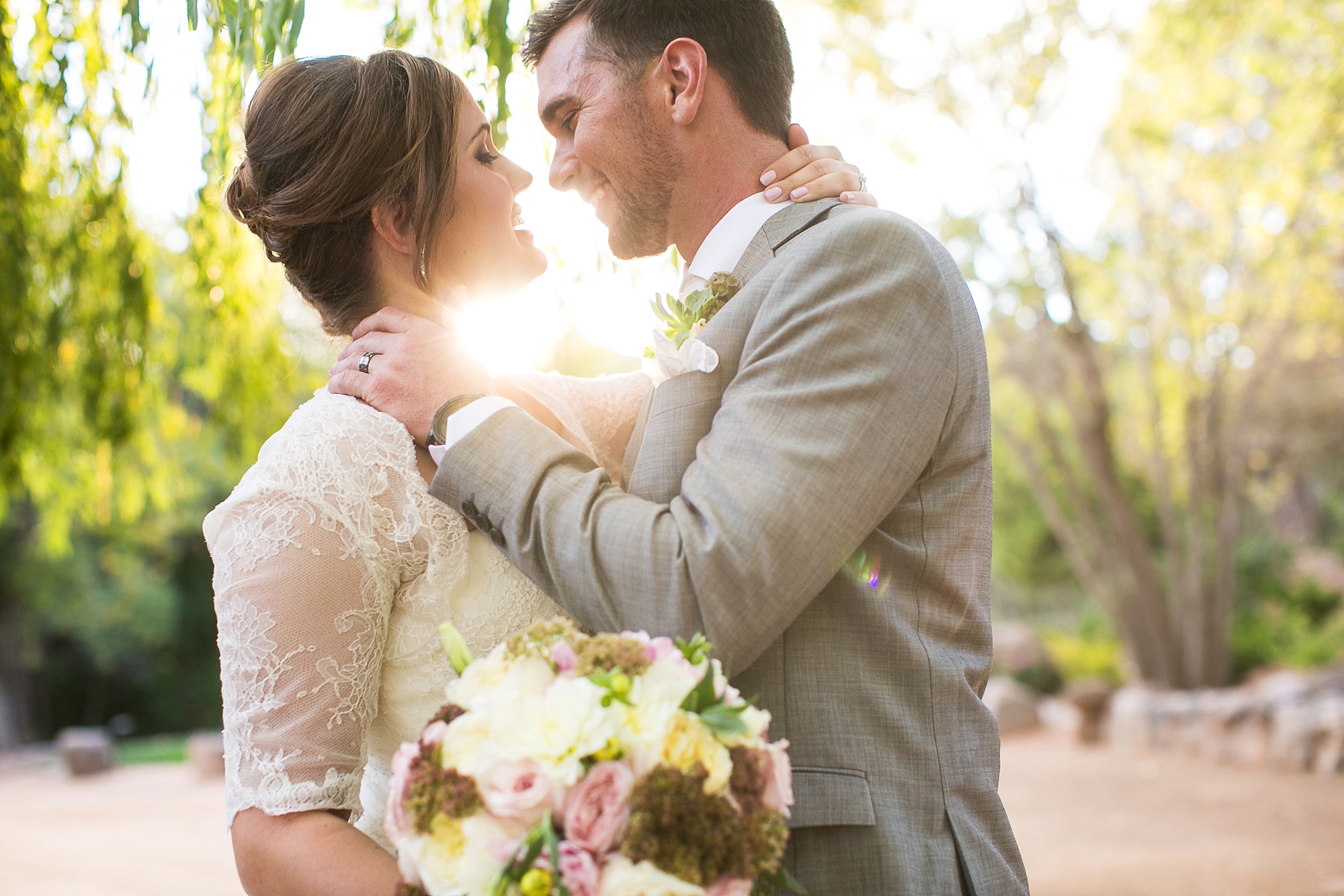 Bride and being romantic with the light setting behind them at Dancing Apache Lodge