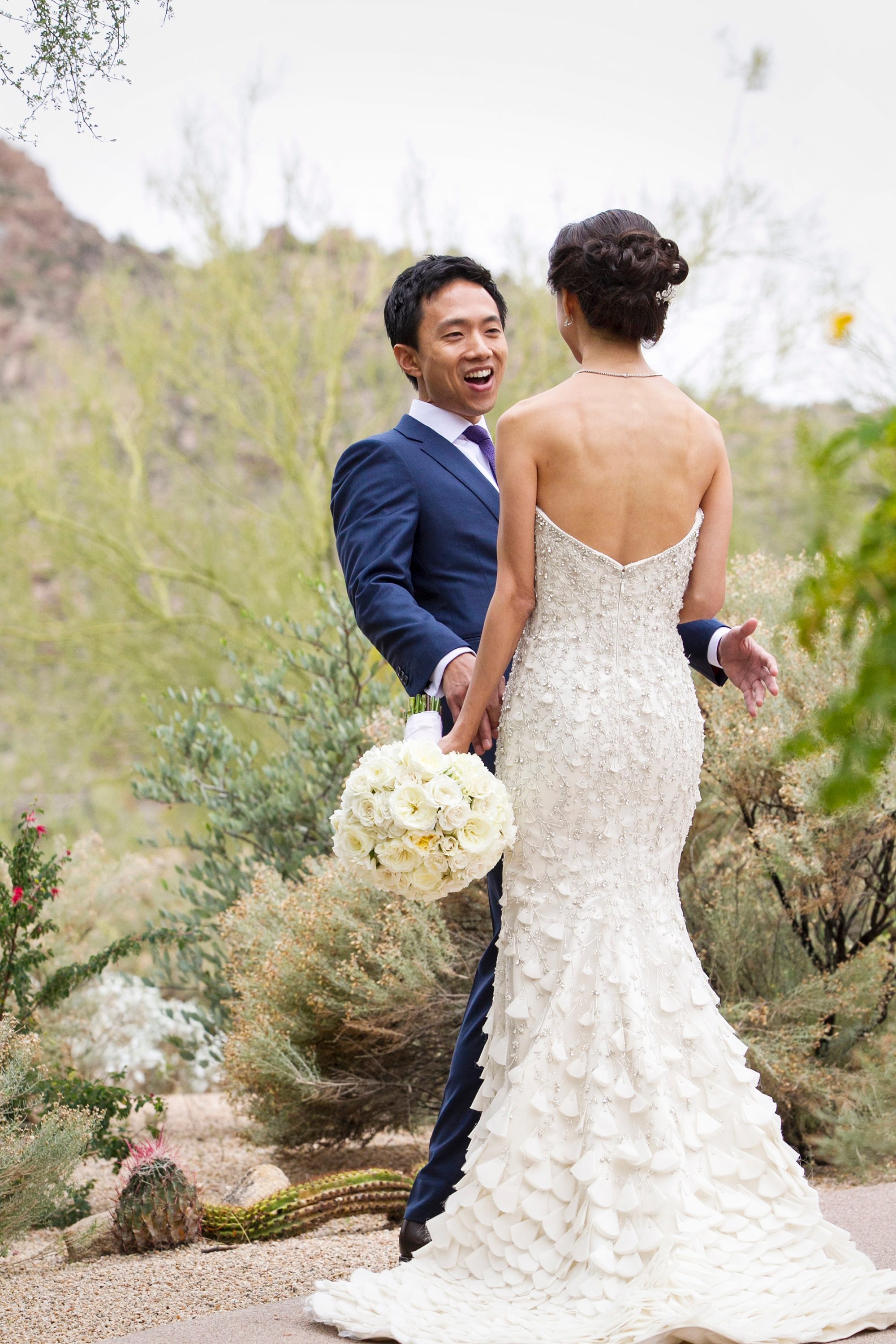 A groom sees his bride for the first time on their wedding day at the Four Seasons Scottsdale