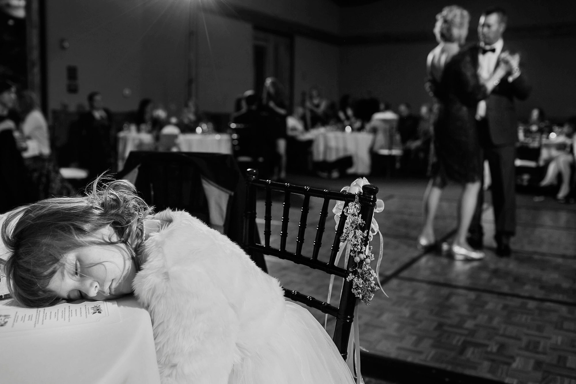 Little girl sleeping during a wedding reception at Enchantment Resort