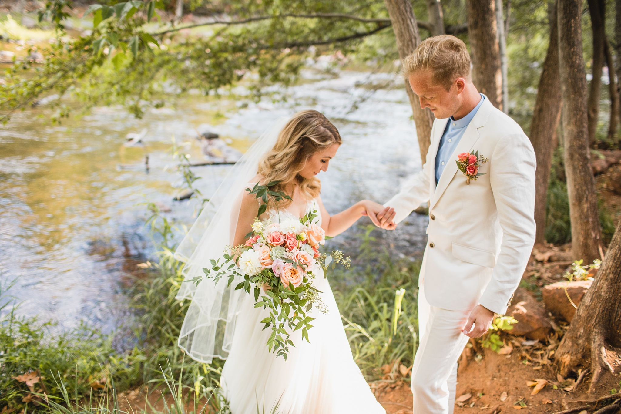 L'Auberge wedding photos by Oak Creek a bride walks with her groom both wearing white