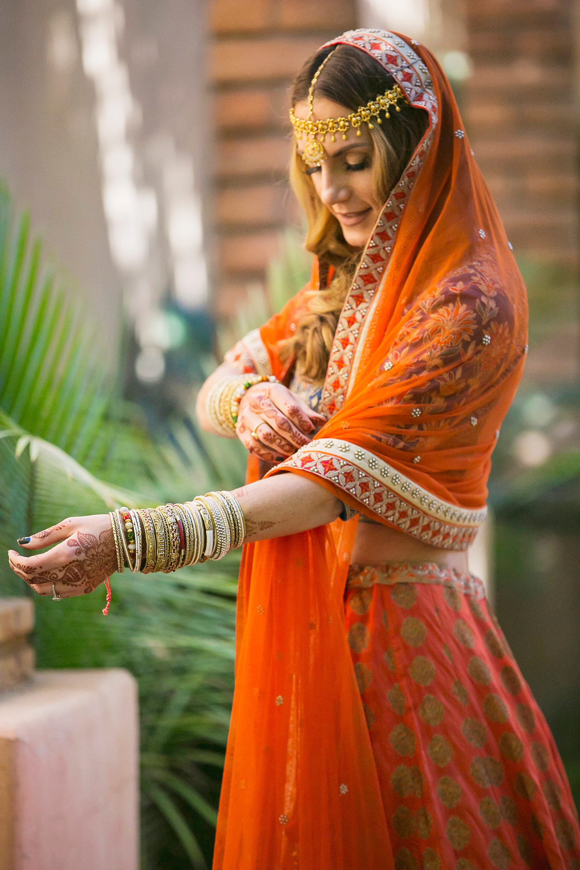 Royal Palms East Indian Wedding photography of a bride in orange and gold