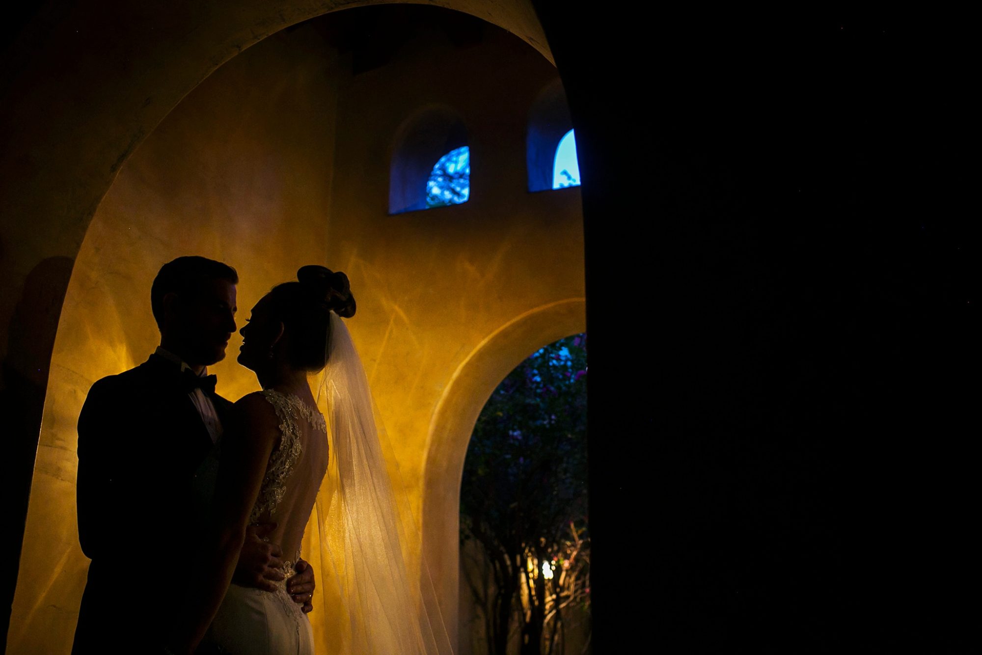 Royal Palms wedding photo silhouette of a bride and groom and arch architecture