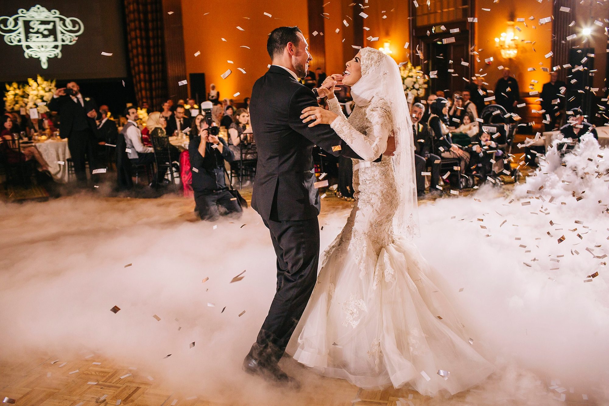 Scottsdale Resort wedding Mccormick Ranch multicultural wedding reception photo of a bride and groom dancing as confetti falls from the air